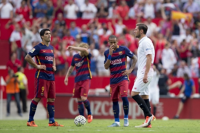 SEVILLE, SPAIN - OCTOBER 03: Luis Suarez (L) of FC Barcelona reacts with teammate Neymar JR. (R) and Ivan Rakitic (2ndL) as Sevilla FC palyers celebrate their first goal during the La Liga match between Sevilla FC and FC Barcelona at Estadio Ramon Sanche
